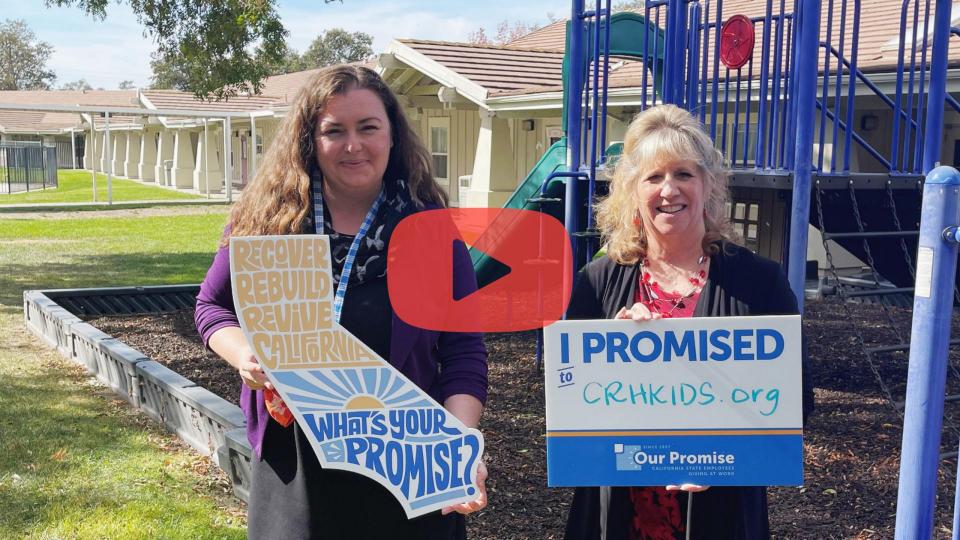 Two white women holding signs with a playground in the back. Taller woman with curly hair holding a cutout of California that reads "RECOVER. REBUILD. REVIVE CALIFORNIA. WHAT'S YOUR PROMISE? Other woman with blonde hair holding rectangular sign that reads "I PROMISED. CRHKids.org"