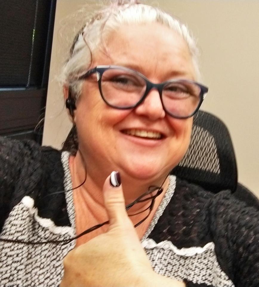 White woman in glasses with light gray hair